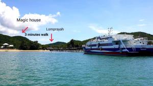 a large boat in the water next to a dock at Magic House - No Pets Allowed in Chumphon