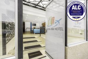 an entrance to an airport with a sign on a glass door at Ayenda 1024 Agora Inn Hotel in Bogotá