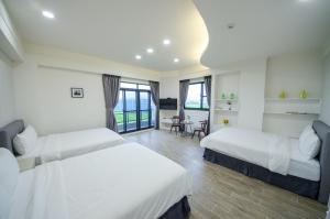 En eller flere senger på et rom på 渡小夜電梯民宿 Yilannight B&B