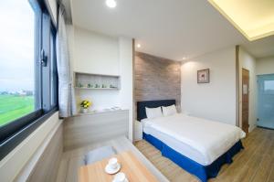 En eller flere senger på et rom på 渡小夜電梯民宿 Yilannight B&B