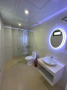 a bathroom with a toilet and a sink and a mirror at SEN HIDDEN CHARM in Con Dao
