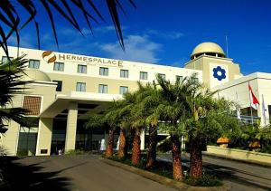 a large building with a clock on the side of it at Hermes Palace Hotel Banda Aceh in Banda Aceh