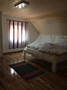 a bedroom with a bed in a attic with a window at Bella Badacsony Apartmanház in Badacsonytomaj