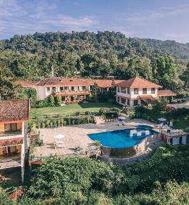 an aerial view of a house with a swimming pool at Amritara Ambatty Greens Resort in Virajpet