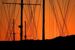a silhouette of two poles with power lines at sunset at Guest House Dijana in Korčula
