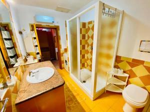 a bathroom with a sink and a shower at Le case di Helga in Budoni +47 photos