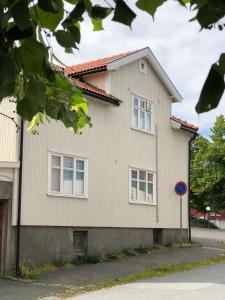 a white house with a red roof at Skarmyra Apartment in Moss