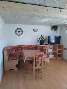a living room with a table and a couch at Apartmán Pavla in Ostružná