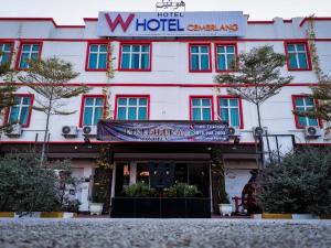 a large white building with a sign in front of it at W Hotel Cemerlang in Kota Bharu