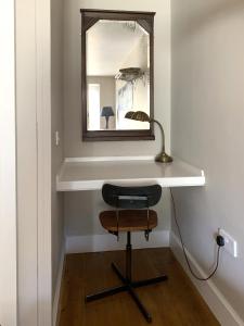 a desk with a mirror and a chair in a room at Little Doric in Shepton Mallet +13 photos