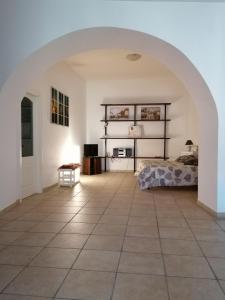 a large room with a bed and a tiled floor at La piazzetta in Pignola