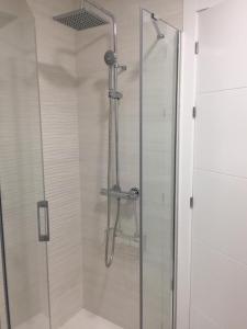 a shower with a glass door in a bathroom at Sol de Verano in A Coruña