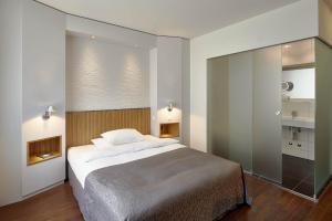 A bed or beds in a room at Sorell Hotel Rütli