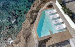 an overhead view of a swimming pool and the ocean at Iliada Suites in Naxos Chora