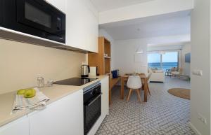 a kitchen and living room with a view of the ocean at BLAU Apartamento en Cala Galiota con vistas al mar in Colonia Sant Jordi
