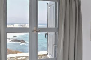 an open window with a view of the ocean at Iliada Suites in Naxos Chora
