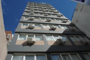 a tall building with air conditioners on it at Hotel Juramento in Buenos Aires
