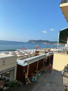 a view of a beach with umbrellas and the ocean at appartamento fronte mare con terrazzo in Alassio