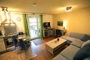 a living room with a couch and a table at Ferienwohnung „Alte Mühle“ in Bad Rodach