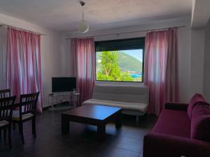a living room with a couch and a window at Aegli in Vasiliki