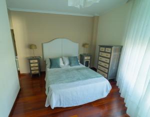 a bedroom with a bed and two night stands at HyP - LA CASA DE LAS HORTENSIAS in Pontevedra