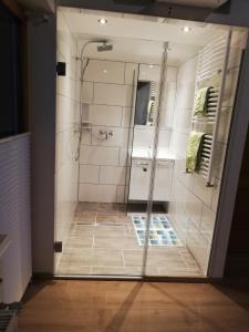 a shower with a glass door in a bathroom at Gästehaus Ferner in Sankt Michael im Lungau