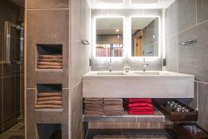a bathroom with a sink and a mirror and towels at MACHIYA-VILLA SEIAN in Fukuoka +26 photos
