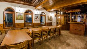 a dining room with a long table and chairs at Къща за гости Черна река in Ribarica +22 photos