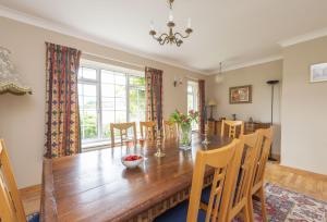 a dining room with a wooden table and chairs at Greygles in Dorchester