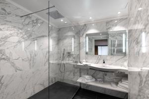a bathroom with a sink and a glass shower at Juliana Hotel Cannes in Cannes