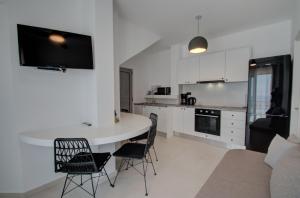 a kitchen with a table and chairs in a room at Pyrgos Exclusive , Sea View & Private Pool in Sellía