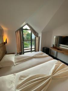 two beds in a room with a window at MİYAS LUXURY HOTEL in Kemer