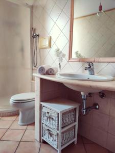 a bathroom with a sink and a toilet and a mirror at Your home in Bonaria in Cagliari