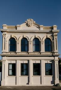 a building with a lion on the top of it at The Old Confectionery in Oamaru