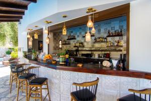 a bar with a row of chairs and a counter at MEGA AMMOS HOTEL in Syvota
