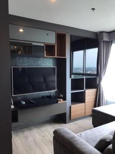a living room with a large flat screen tv at Stunning Seaview Suite in Jomtien Beach
