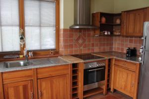 a kitchen with a sink and a stove top oven at Ferienwohnung Alpenrose in Goldegg