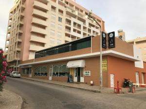 a building on the side of a street at Casa Caravela B in Armação de Pêra +5 photos