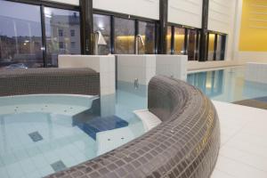 a swimming pool in a building with a swimming pool at SpaHotel Hamina in Hamina