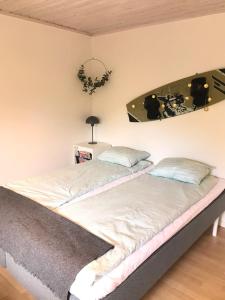 a bedroom with two beds and a mirror on the wall at 3:e Sandbank in Beddinge Strand