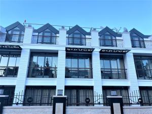 a white building with windows and balconies on it at MİYAS LUXURY HOTEL in Kemer