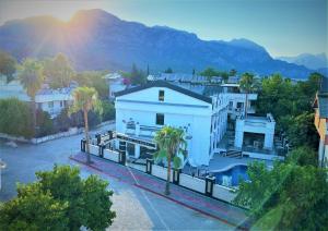 an aerial view of a white building with palm trees at MİYAS LUXURY HOTEL in Kemer