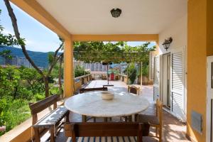 a patio with a table and chairs on a balcony at Apartments Antic in Budva