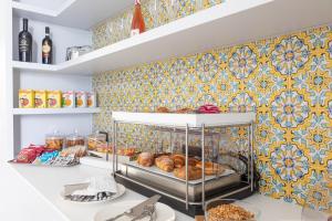 a bakery with bread and pastries on a wall at Santa Caterina - Dimora sul mare in Polignano a Mare