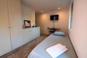 a bedroom with a bed and a tv in it at Quinta da Malaposta - Boutique Hotel & Eventos in Vila Nova de Cerveira