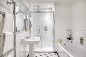 a white bathroom with a sink and a shower at Ensana Buxton Crescent in Buxton