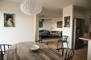 a dining room and living room with a table and chairs at CALADEA Locations de Vacances 5 étoiles, piscine chauffée in Porto-Vecchio