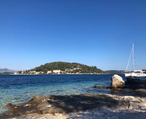 a boat is docked on the shore of a body of water at Guest House Dijana in Korčula
