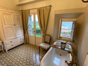 a bathroom with a tub and a sink and a window at Can Massana in Pau