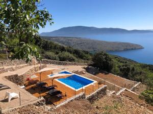 a swimming pool with a view of a body of water at Vita Vacation Home in Ustrine